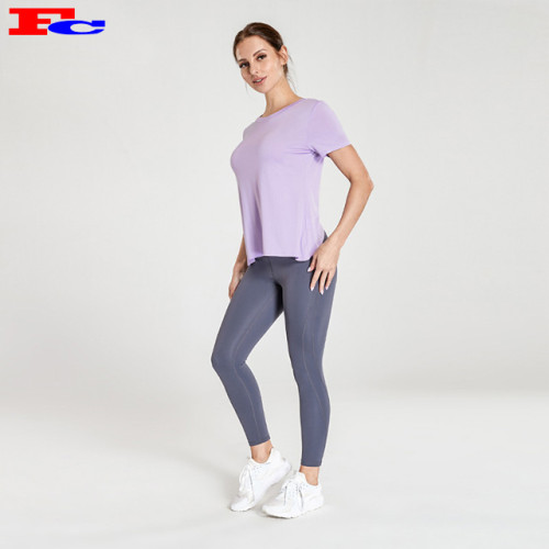 Produttori di abbigliamento da allenamento per maglietta viola chiaro con incrocio sul retro e leggings grigio scuro
