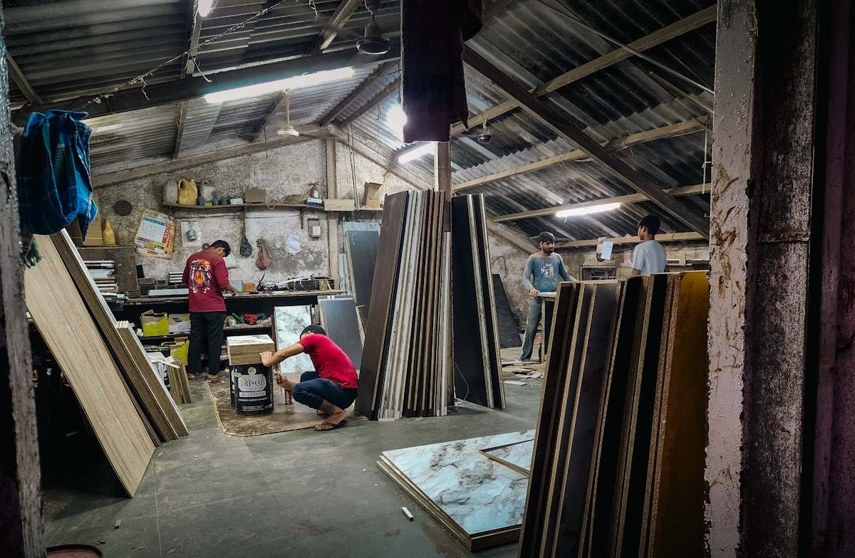 Workers in a workshop handling wood materials