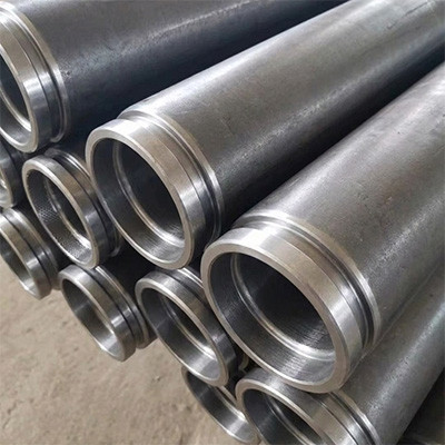 Close-up of industrial steel pipes with precision-machined end grooves arranged in a neat stack, showing high-quality fabrication