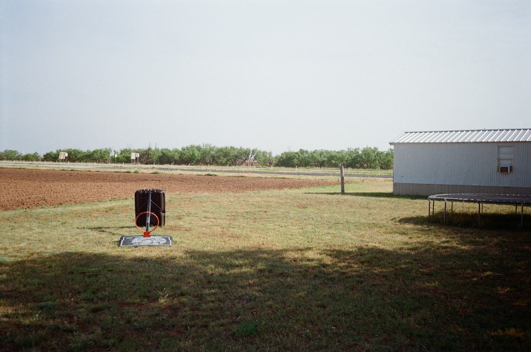 A solar fence energizer mounted on a post in a field