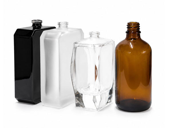A regular size perfume bottle held in the hand showing everyday scale