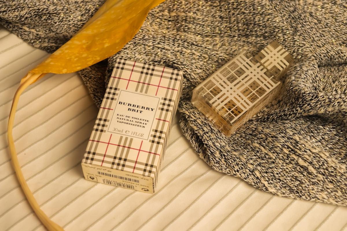 Custom perfume box and glass fragrance bottle styled on textured fabric