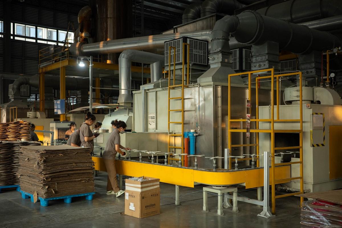 Perfume box factory workshop with box-making machinery and stacked cartons
