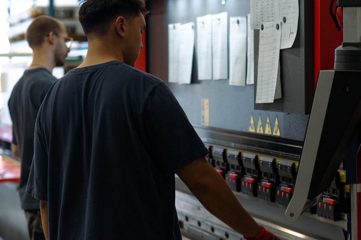 Two technicians setting up a machine on the perfume packaging production line