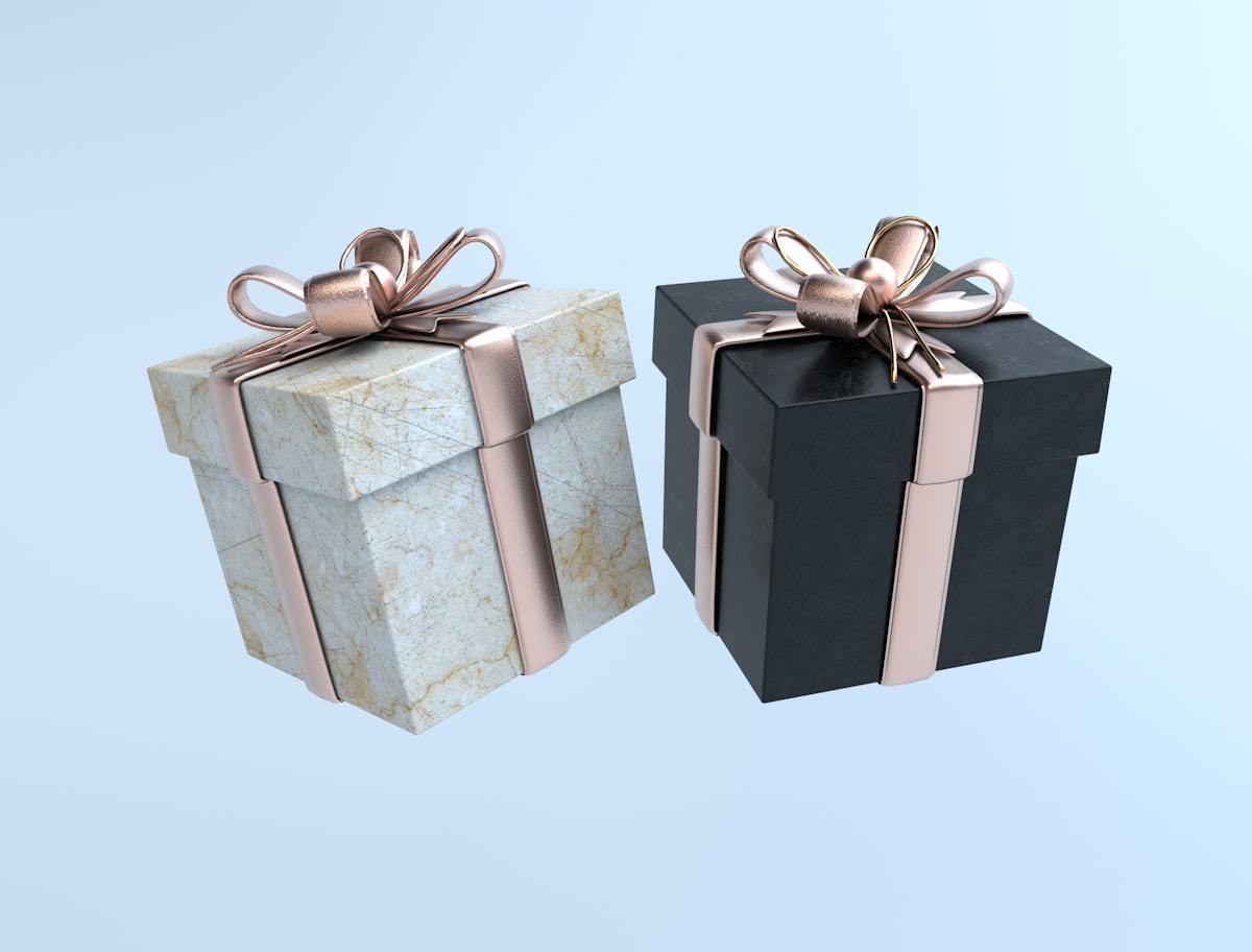 Rigid two-piece perfume gift boxes finished with gold ribbon detail