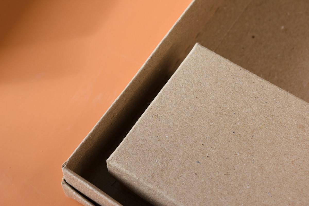 Open folding carton perfume packaging on a workbench before assembly