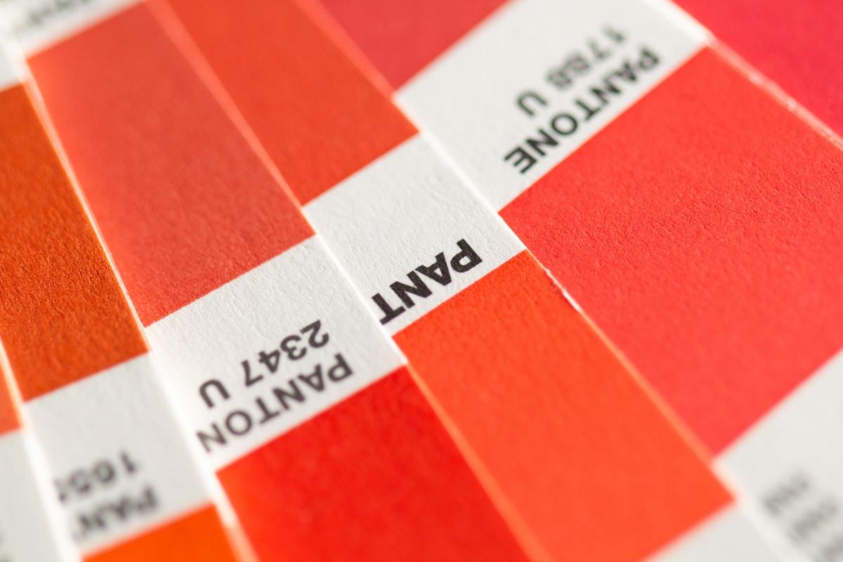 Orange and white printed board samples used for custom perfume box production
