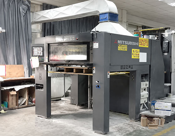 Perfume box factory workshop with box-making machinery and stacked cartons