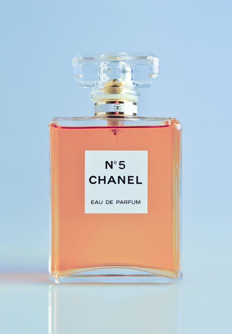 Custom perfume bottle with premium decoration finish on a styled background