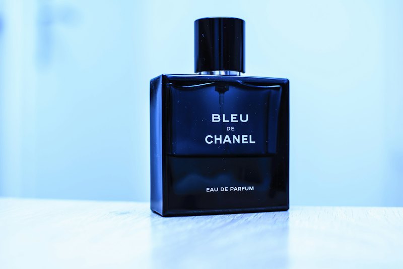 Perfume bottle with a gold hot-foil stamped metallic logo accent
