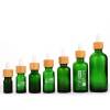 زجاجات قطارة زجاجية مخصصة | زجاجات من الضروري النفط اليورو الأخضر مع قطارة الخيزران