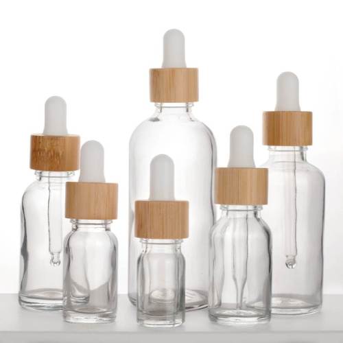 Botellas de aceite esencial con gotero de vidrio transparente europeo al por mayor | cuentagotas de bambú