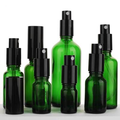 Botellas de spray de bomba de vidrio verde personalizadas para aceites esenciales, tóner
