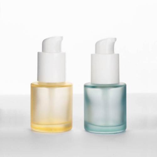 Botellas de suero cosmético de vidrio cilíndrico de 20 ml al por mayor con bomba para aceites capilares, base