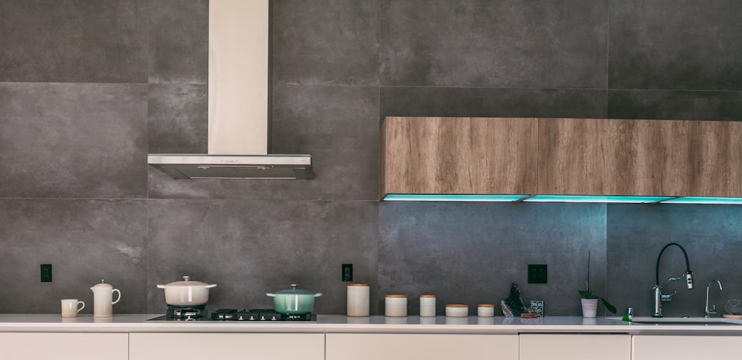 A modern kitchen with a sleek, integrated smart cooker hood above the stove