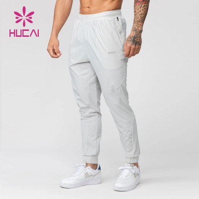 HUCAI Hot Sale Gym Sweatpants Zipper Pockets Screen Printing Drawstring Joggers Supplier