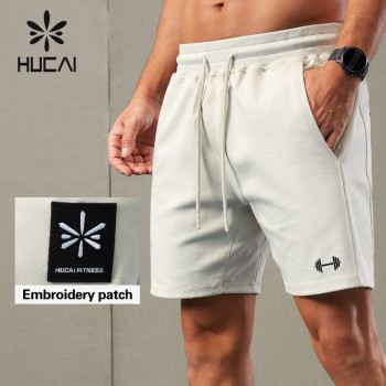 HUCAI ODM Running Shorts Waterproof Zipper Asymmetrical Design Sportswear OEM