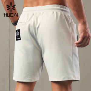 HUCAI ODM Running Shorts Waterproof Zipper Asymmetrical Design Sportswear OEM
