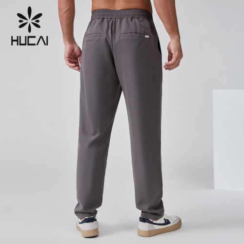 HUCAI OEM Men's Joggers Button Woven Label Rivets Zipper Leisure Sports Pants Manufacturer