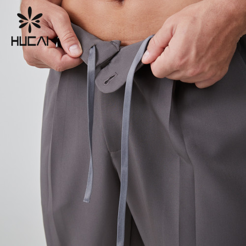 HUCAI OEM Men's Joggers Button Woven Label Rivets Zipper Leisure Sports Pants Manufacturer