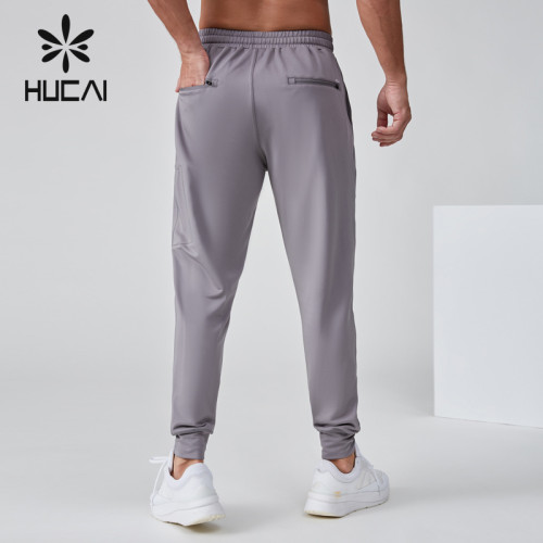 HUCAI OEM Men's Jogger Silicone Logo Embroidery Waterproof Zipper Sports Pants Manufacturer