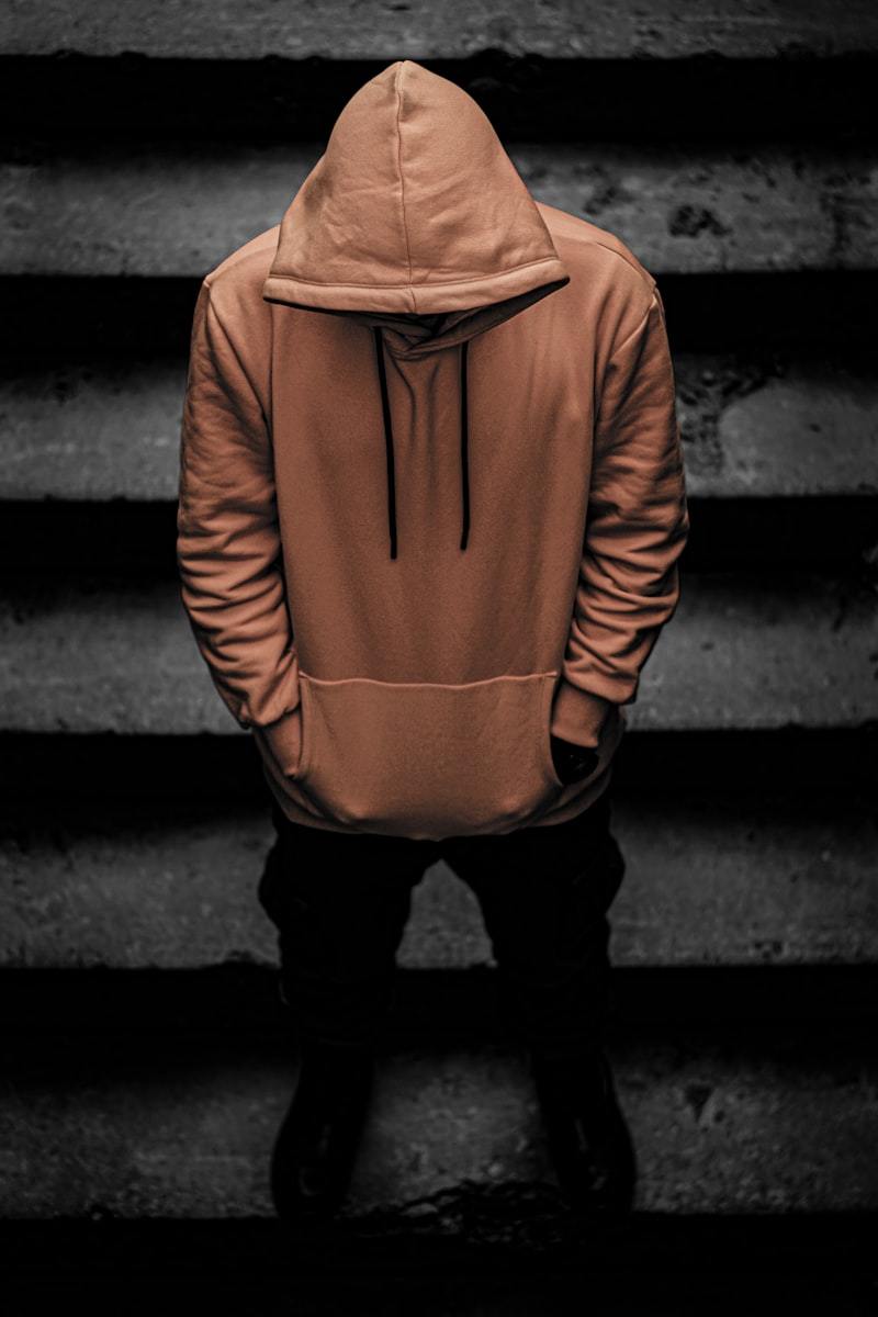Close-up of a premium men's hoodie showing hood structure and drawcord detail