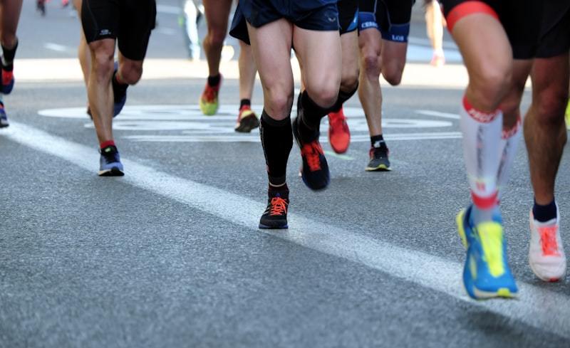 Men running on a road in lightweight race activewear