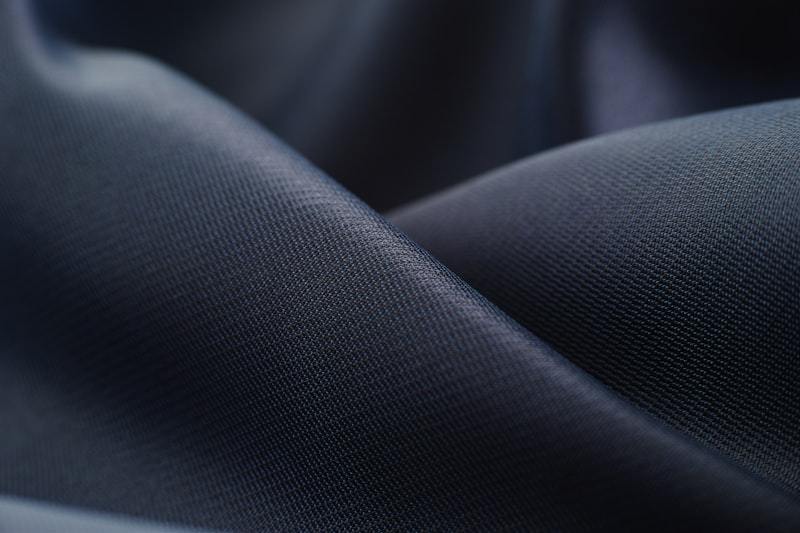 Close-up of white performance textile showing knit structure used as a men's activewear fabric platform