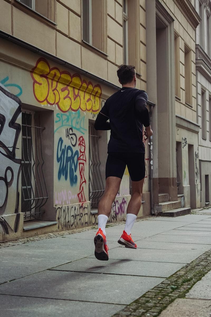 Athlete jogging outdoors in shorts and a top during a real-world wear test of men's activewear