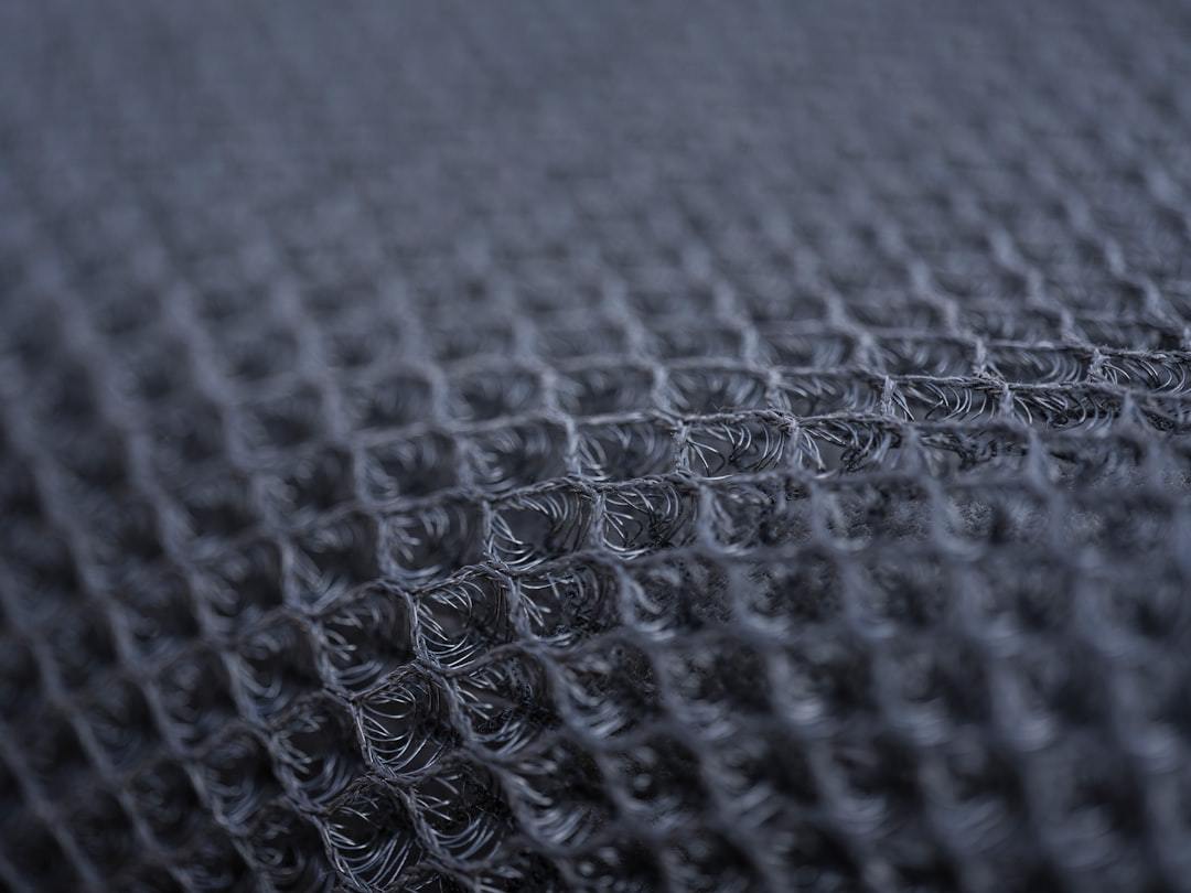 Macro view of an open 3D mesh knit structure used for ventilation panels in technical running tops