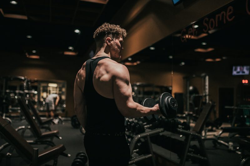 man holding a dumbbell in a gym