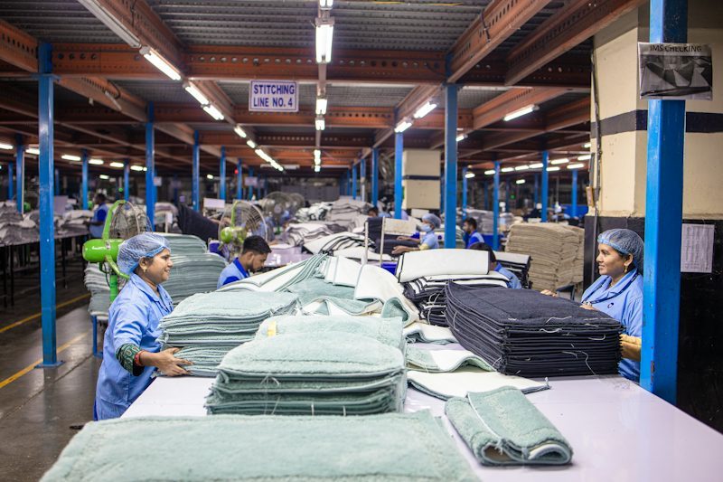 textile workers sorting fabric in a factory
