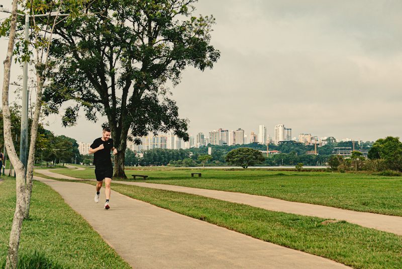 man running along a park path