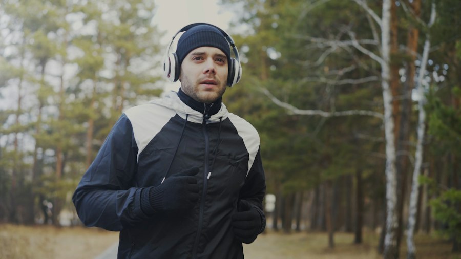 Runner wearing a lightweight technical outer layer on a cold forest trail