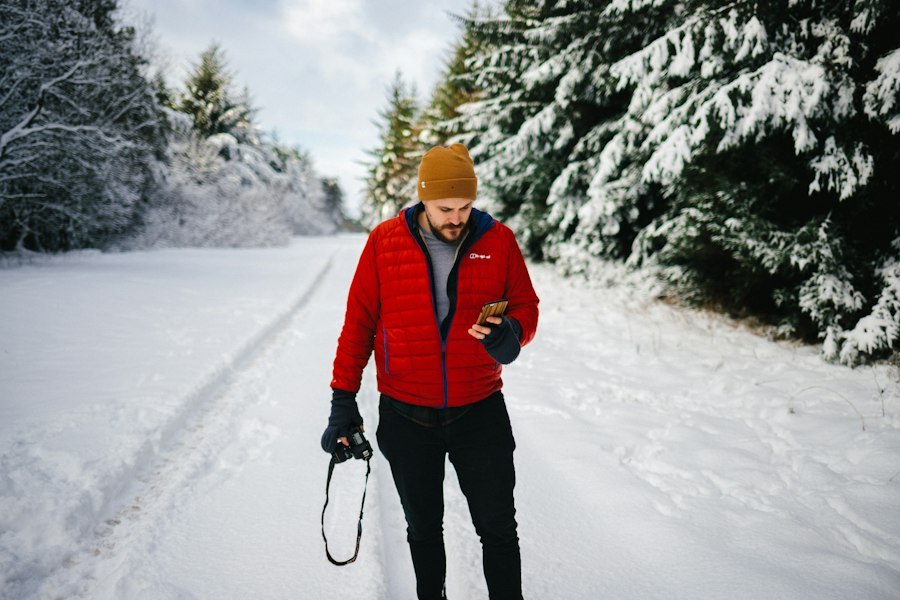 Runner in cold weather wearing a technical layer while running on a snow-covered road