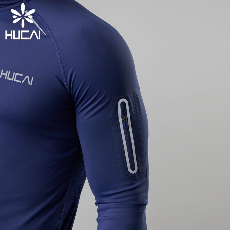 Close up of the sleeve and arm construction on a men's navy compression fit long sleeve base layer top