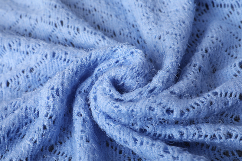 tassels on knitted blanket