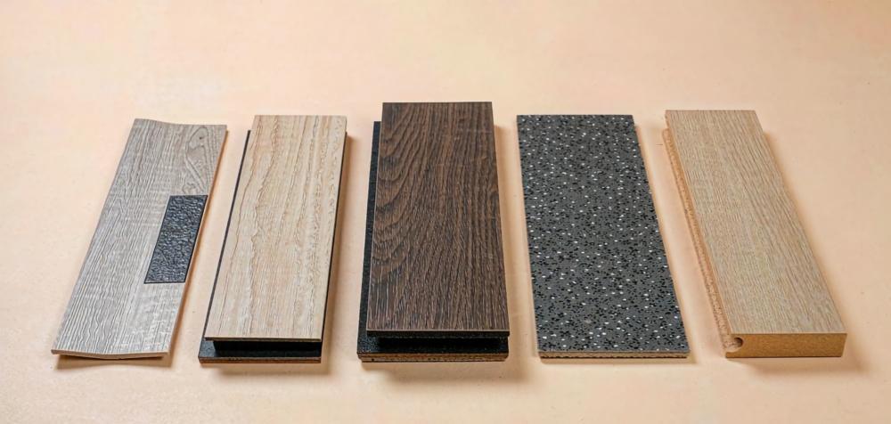 Five commercial vinyl flooring sample planks showing different thickness and construction side by side