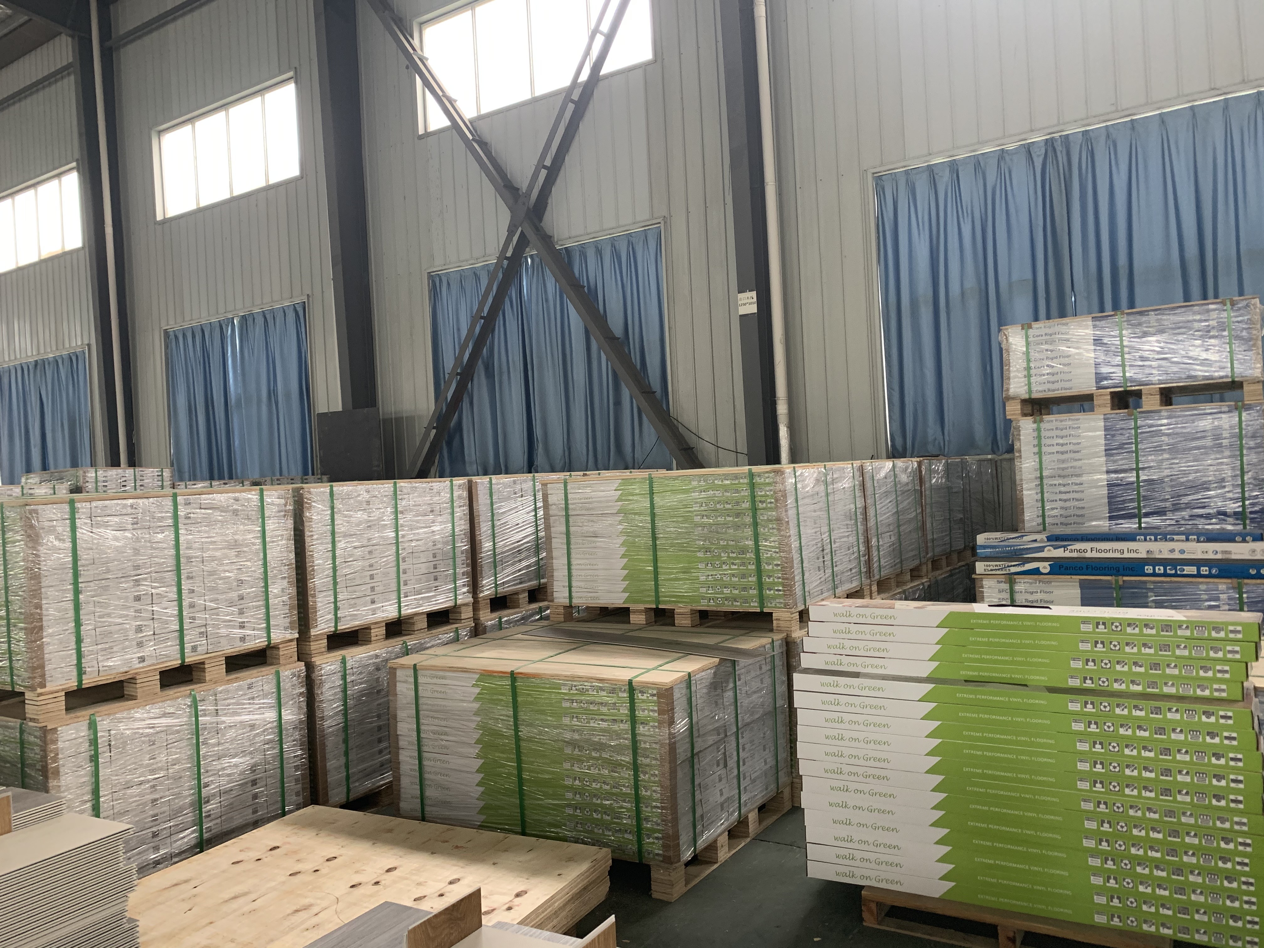 Warehouse with pallets of vinyl flooring cartons ready for commercial distribution