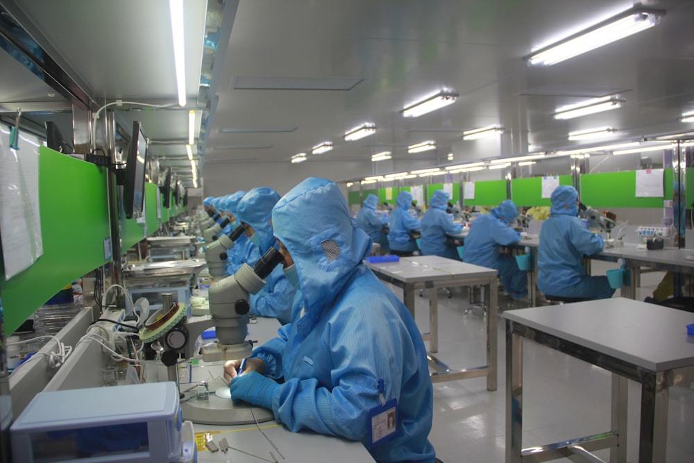 Worker in protective clothing inside a controlled clean environment