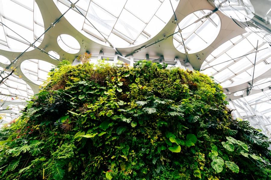 Lush green plants growing under a modern glass ceiling