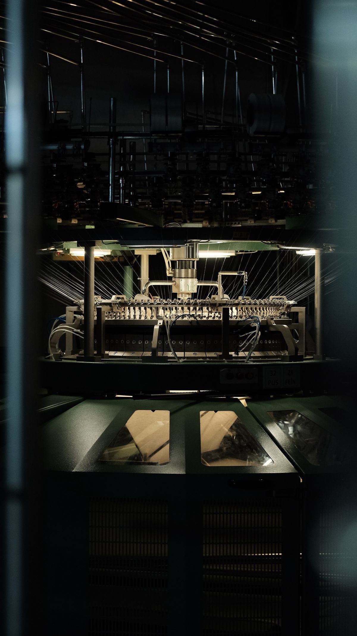 Industrial textile machine operating on a spinning floor inside a textile manufacturing plant