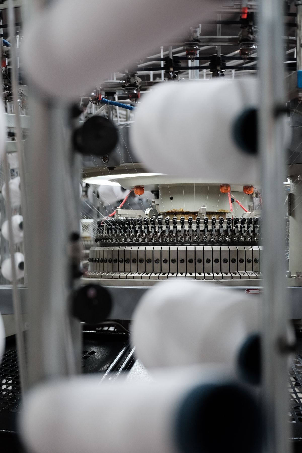 Industrial textile spinning machine running on a factory floor