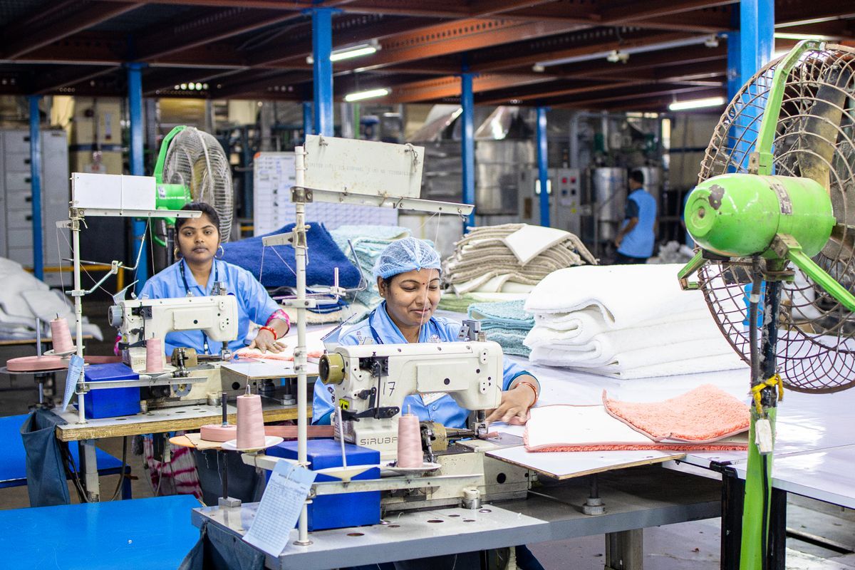 Textile factory workers operating sewing machines in a garment workshop