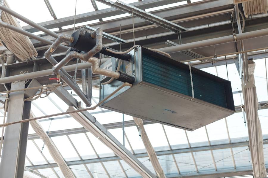 Ceiling-mounted industrial dehumidification unit installed in a building services void