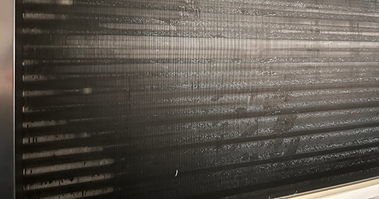 Close-up of a metal surface with water drops, illustrating corrosion-resistant coating