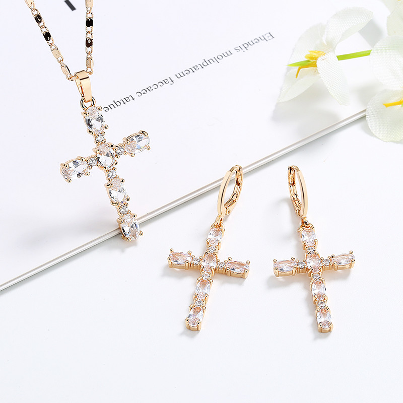 white cross pendant necklace with matching earrings