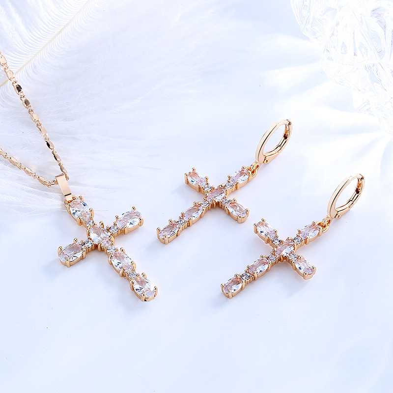 white cross pendant necklace with matching earrings