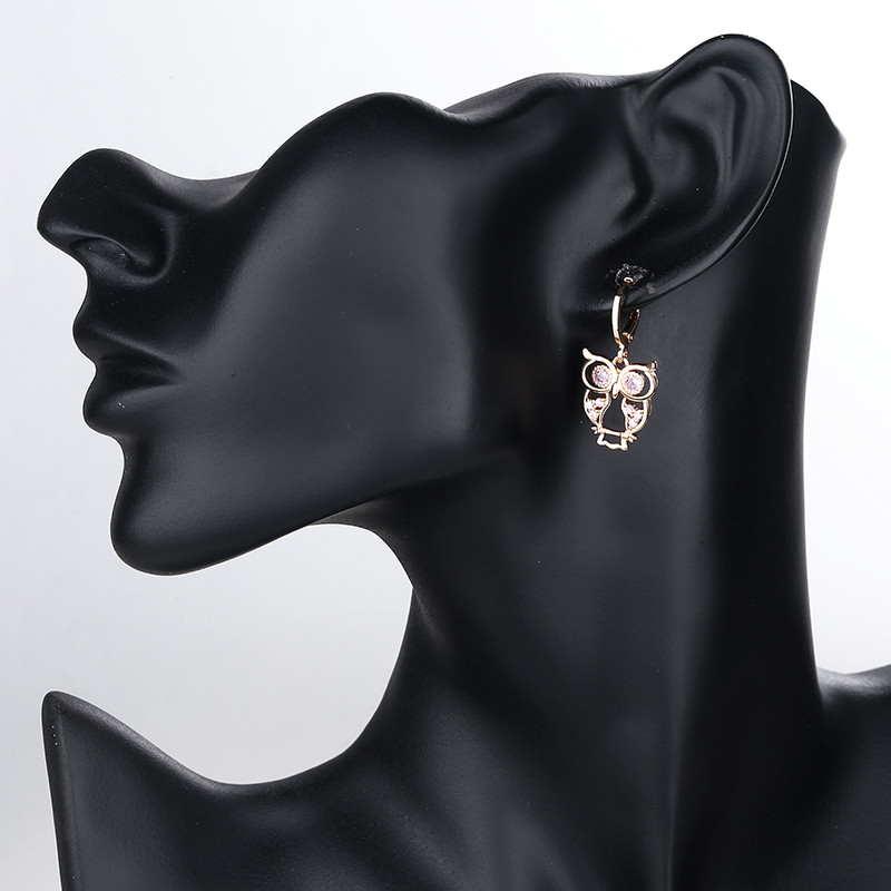 wearing black owl dangle huggie earring