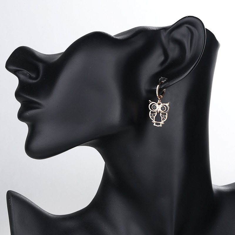 wearing black owl dangle huggie earring